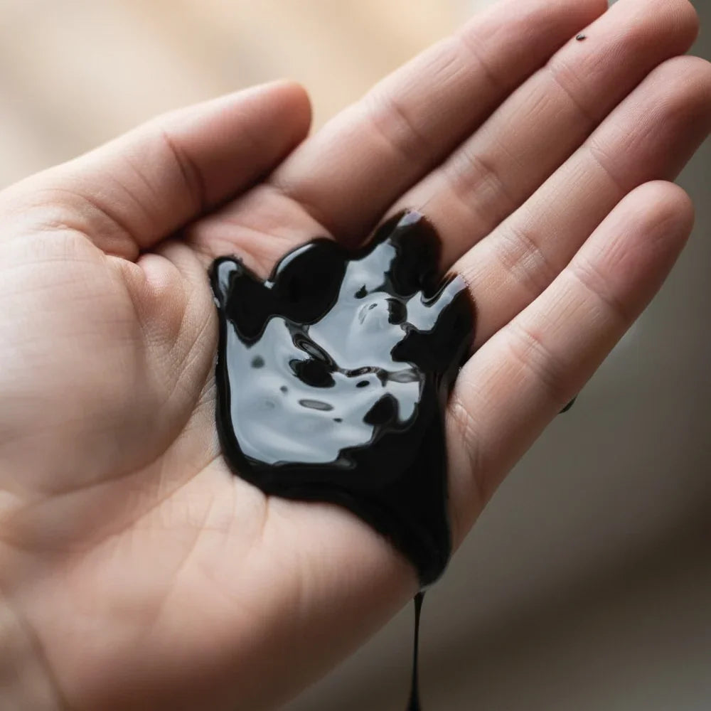 Schwarzes Gleitgel in der Hand, ideal für intime Momente und Liebesleben