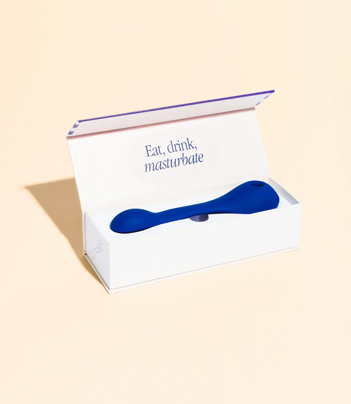 Blauer Vibrator in weißer Verpackung mit Text 'Eat, drink, masturbate' – Intimspielzeug für das Liebesleben