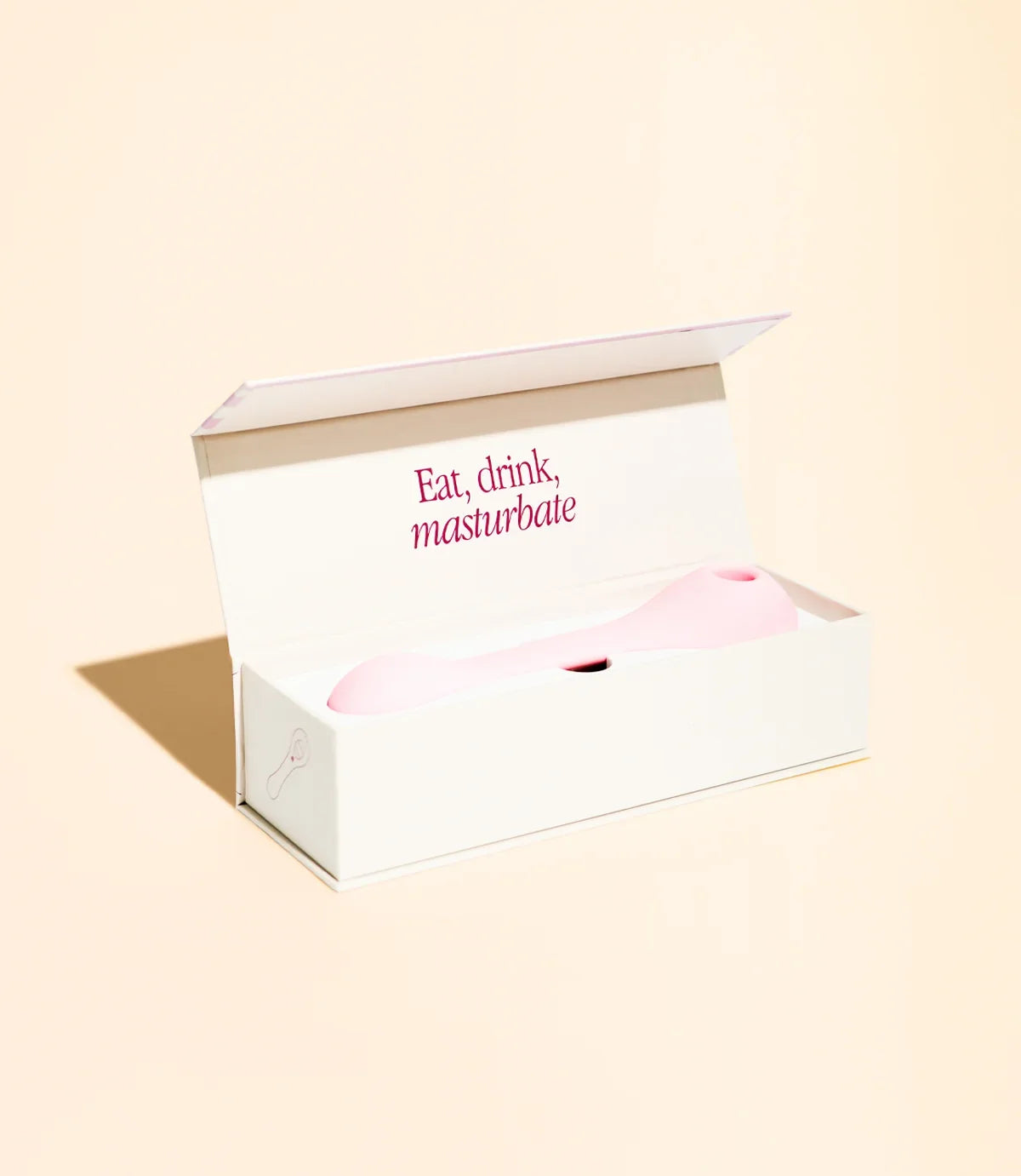 Rosa Vibrator in weißer Verpackung mit Aufschrift 'Eat, drink, masturbate' – Intimspielzeug für Erwachsene