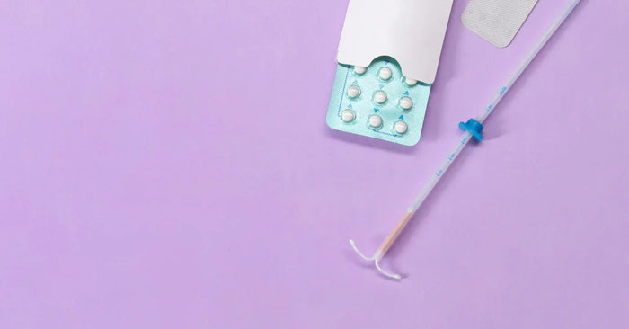 Verhütungsmittel wie Antibabypille, Verhütungspflaster und Spirale auf lila Hintergrund